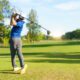 Golfer teeing off.